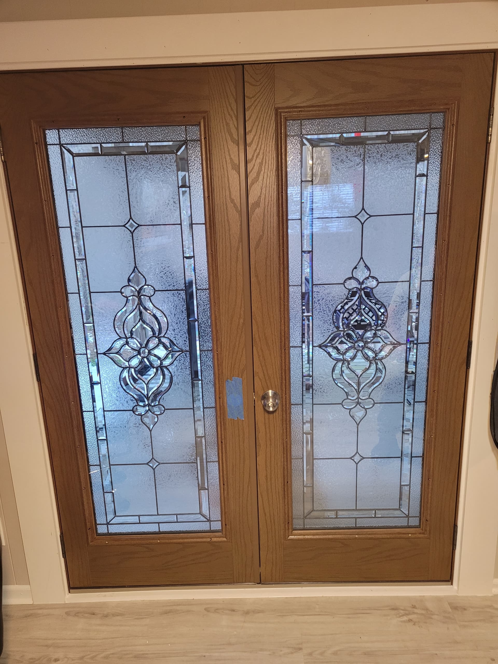 Double entry doors with decorative leaded glass panels