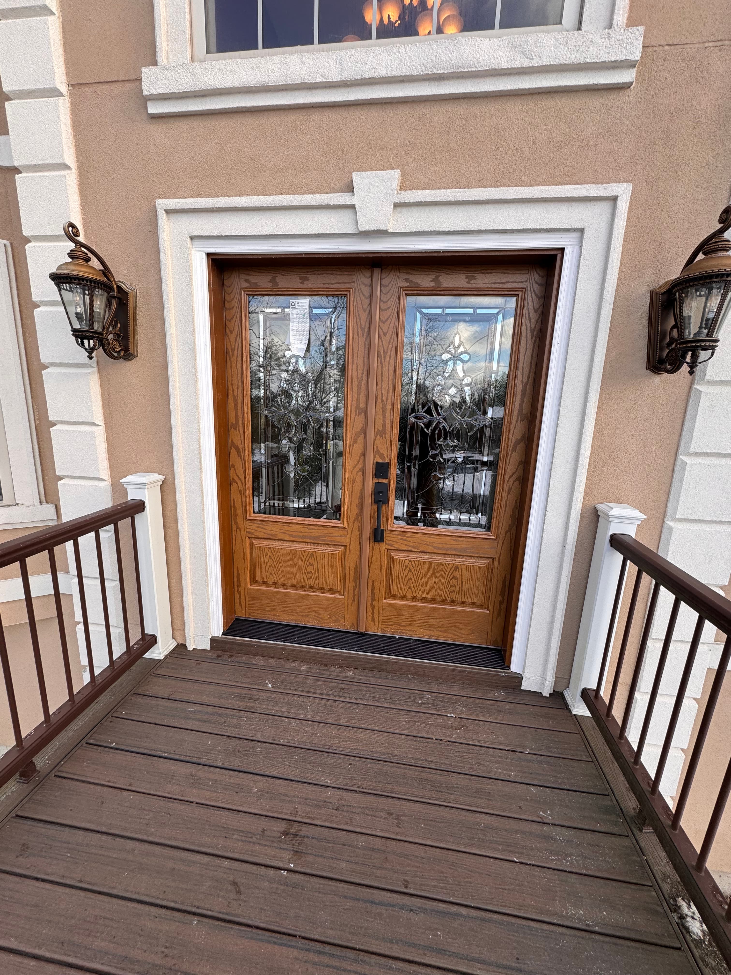 Wood-tone dutch entry door with decorative leaded glass